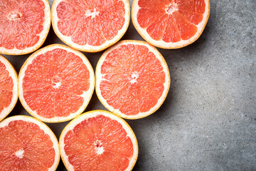 Red grapefruits on stone background