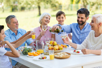 Extended family eating outdoors
