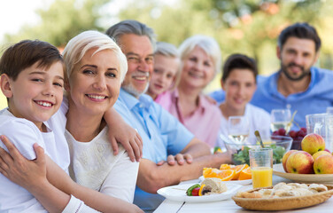 Extended family eating outdoors
