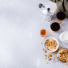 Breakfast with black coffee muesli granola honey nuts milk