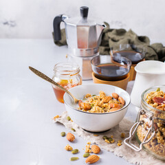 Breakfast with black coffee muesli granola honey nuts milk