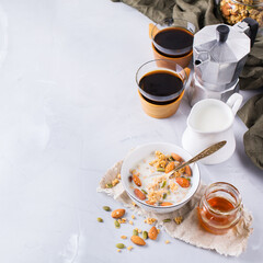 Breakfast with black coffee muesli granola honey nuts milk