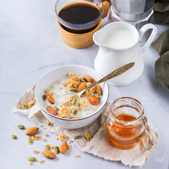 Breakfast with black coffee muesli granola honey nuts milk