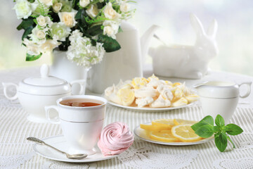 White table with sweets and flowers