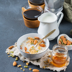 Breakfast with black coffee muesli granola honey nuts milk