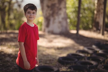 Portrait of smiling boy standing in boot camp