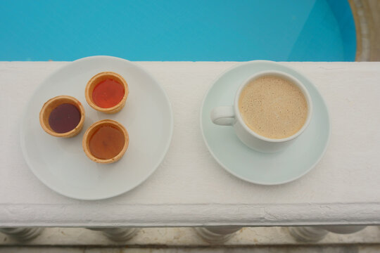 Cup of  coffee  on the background of the pool
