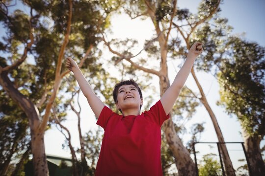 Boy cheering during obstacle course