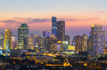 Fototapeta na wymiar View of Bangkok modern office buildings, condominium in Bangkok city downtown with sunset sky ,Bangkok is the most populated city in Southeast Asia. Bangkok , Thailand