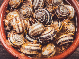 cooked snails, escargots served rustic