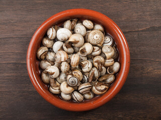 cooked snails, escargots served rustic