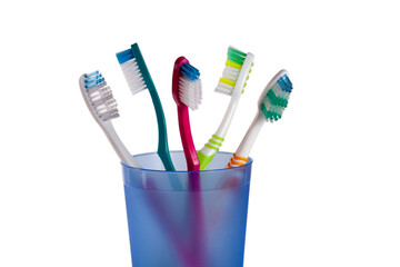 Toothbrushes in blue glass isolated on white background