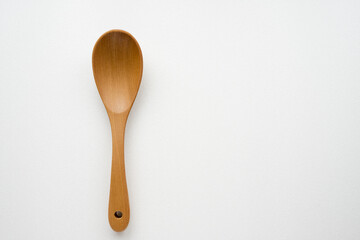 Close-up wooden spoon isolated on white background - obrazy, fototapety, plakaty
