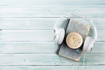 Audio book concept. Headphones, coffee and book