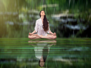 Beautiful girl in Lotus position on the water surface