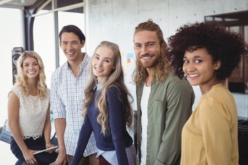 Portrait of smiling business people standing at office