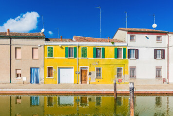 Colored houses reflected in the water. The old street in Comacchio - a small town in the province of Ferrara (Emilia Romagna), also known as 