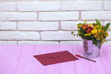 Envelope and a bucket of flowers