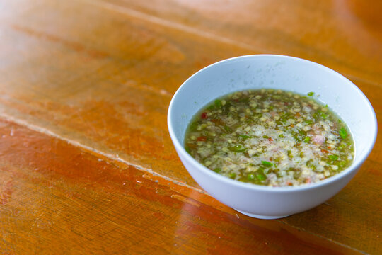 Thai style chilli spicy sauce dipping on wood table, seafood hot dip.