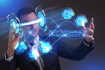 Business, Technology, Internet and network concept. Young businessman working in virtual reality glasses sees the inscription: Performance management