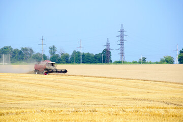 Harvester machine working to harvest wheat field . Combine harvester agriculture machine harvesting golden ripe wheat field. Agriculture