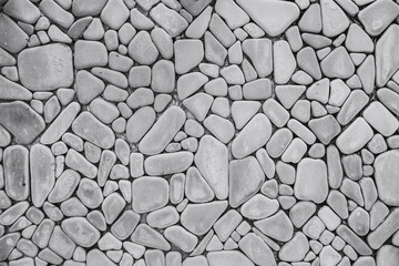 round curved rock wall background. stone decoration wallpaper tile black and white texture pattern.