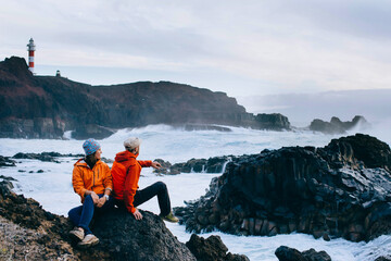 Loving couple admiring the ocean at sunset in the Canary Islands, Spain