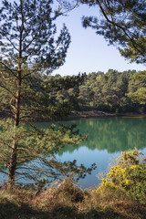 Fototapeta premium Beautiful vibrant landscape image of old clay pit quarry lake with unusual colored green water