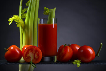 Tomato juice with tomatoes and celery sticks
