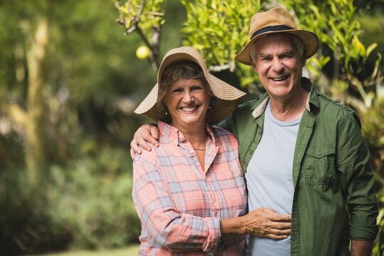 Portrait of smiling senior couple embraing in yard