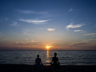 Naklejka na ściany i meble Peaceful meditation sunset on the beach