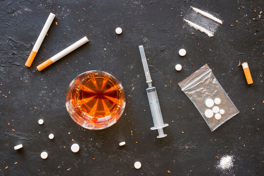 Alcohol, cigarettes and drugs on a black background