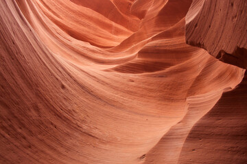 Nature red sandstone textured background. Swirls of old red  sandstone wall abstract pattern in Lower Antelope Canyon, Page, Arizona, USA.