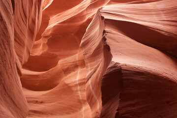Nature red sandstone textured background. Swirls of old red  sandstone wall abstract pattern in Lower Antelope Canyon, Page, Arizona, USA.