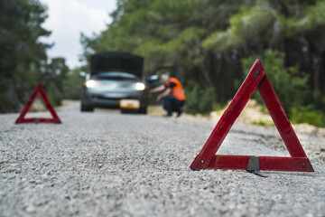 Repairman near broken down car