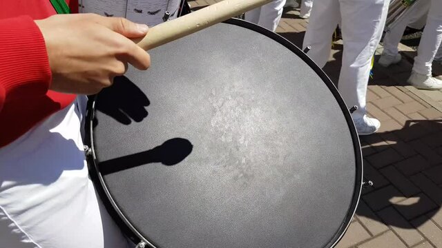 Man is drumming on a big drum
