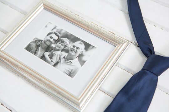 High angle view of picture frame by necktie on table