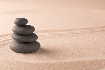 Fototapeta na wymiar zen budhism meditation pile of stones on sand. Paterns for yoga, relaxation and concentration...