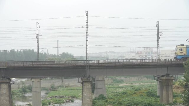 Long goods train traveling on railway Bridge.