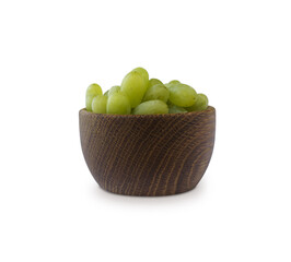 Grapes in a wooden bowl isolated on white background. Green grapes Kish Mish.