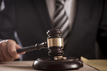 Hand of a judge holding a hammer or gavel