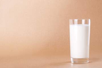 Yogurt in a glass on the beige background appetizing