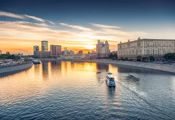 Fotobehang City boat on Moscow river at sunset. Beautiful city landscape © olezzo