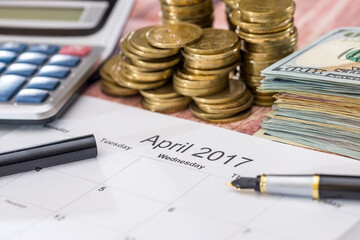 calendar, money, calculator and pen. tax concept. april.