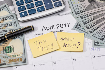 15 april, tax day on calendar with red marker pen with dollar banknote, pen and calculator.