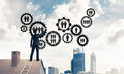 Businessman on house roof presenting teamwork and connection con