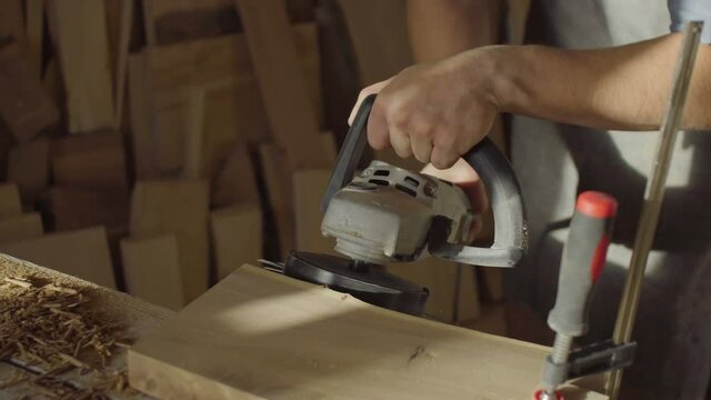 close up hands of woodworker carpenter using brashing scribing machine