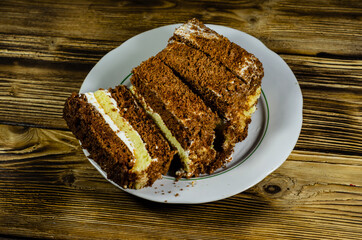 Biscuit cake in plastic container on wooden table