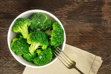 Cooked green broccoli with sea salt and copyspace