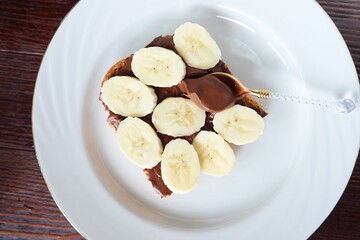 Bread with chocolate pasta and banana for breakfast 